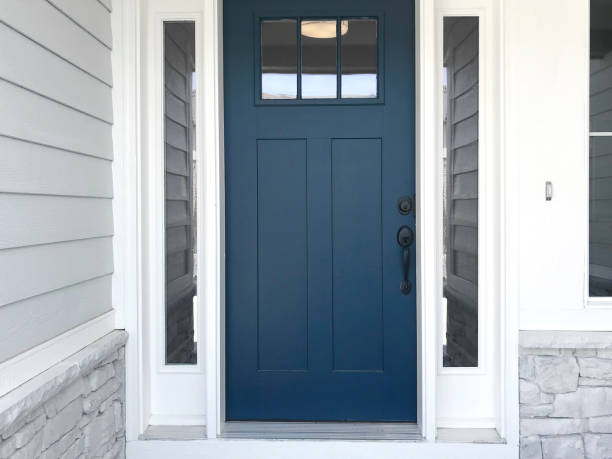 Blue front door of a house with white trim